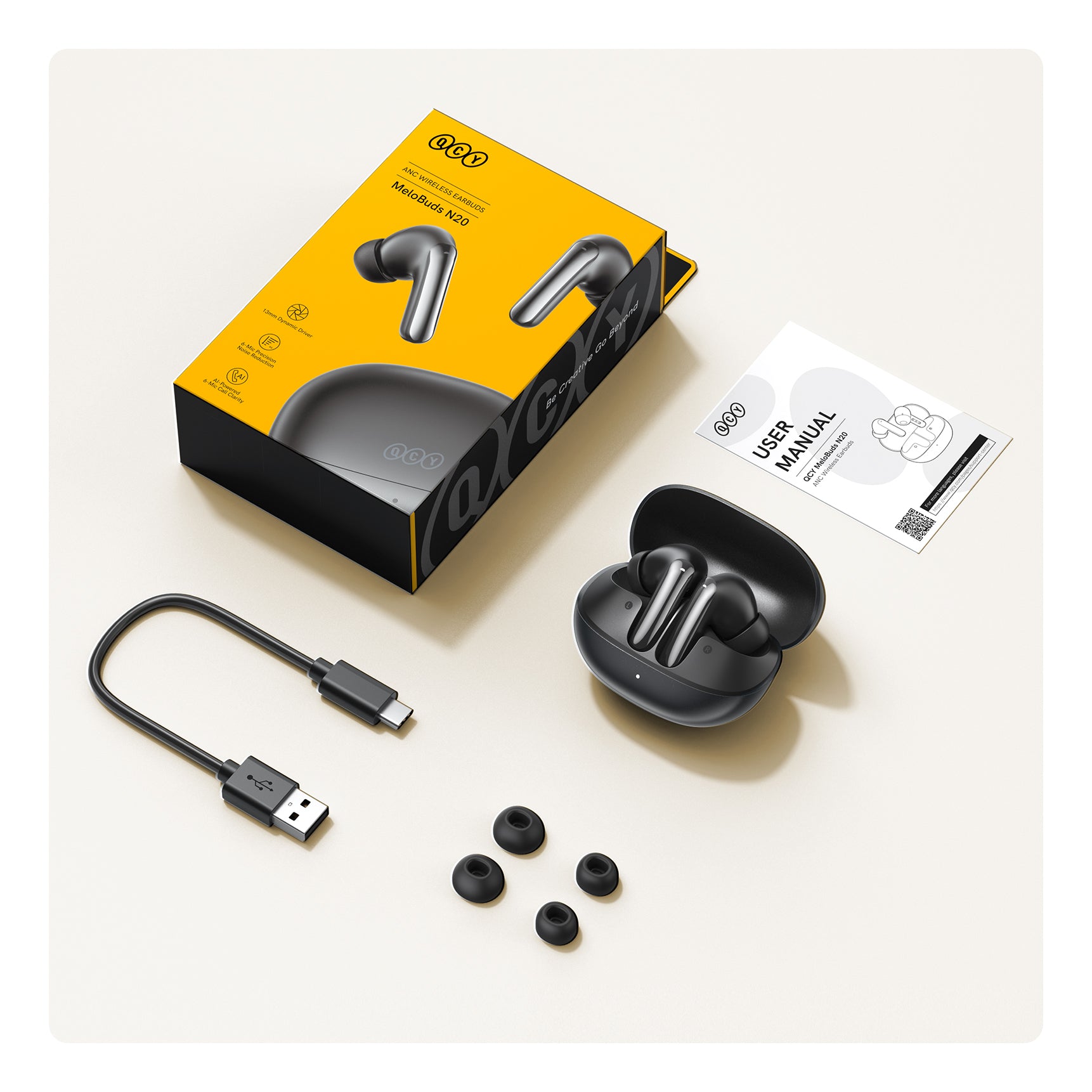 QCY MeloBuds N20 ANC Bluetooth-Kopfhörer mit Ladebox, USB-C-Kabel und Ersatz-Ohrstöpseln.