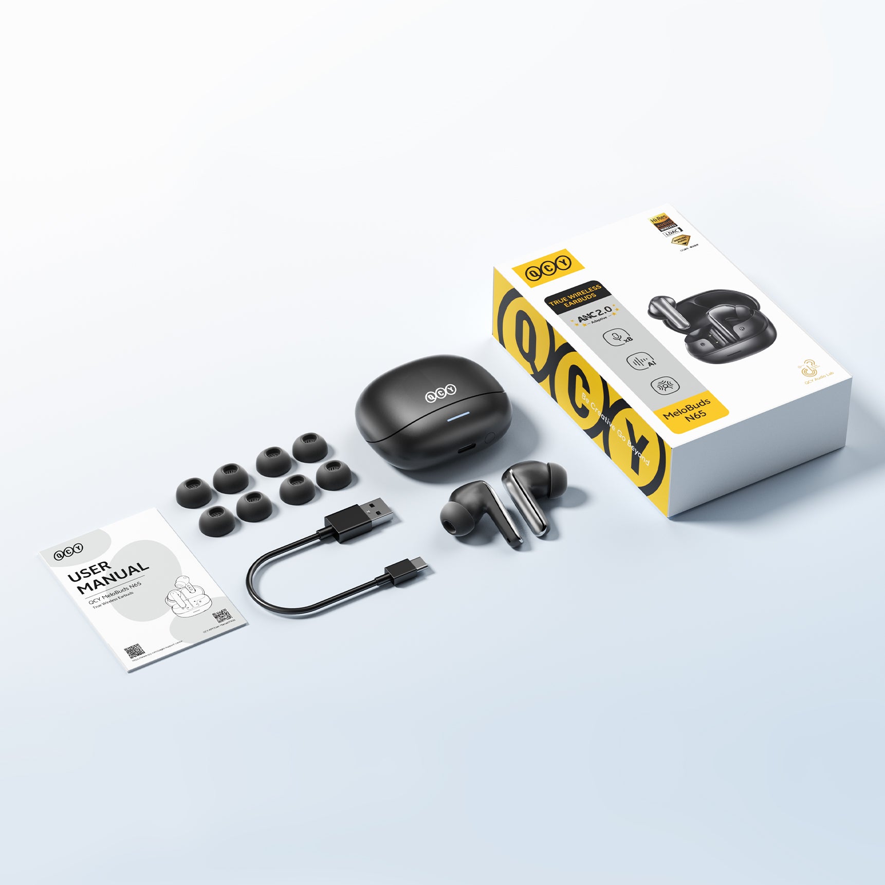 QCY MeloBuds N65 True Wireless Kopfhörer mit ANC, USB-C Ladekabel und Ersatzohrstücken.